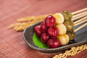 Japanese Dango dessert with 3 different color in pink(red), white, and green, recipe, hanami Dango, tsukimi Dango, copy space.