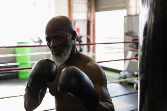 Senior man boxing in the boxing ring