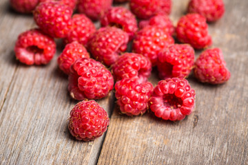Ripe raspberry on the wooden bark. Selective focus. Shallow depth of field.