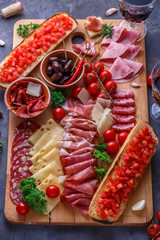 Board of cured meat, cheese and bread with wine