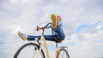 Woman feels free while enjoy cycling. Girl rides bicycle sky background. Cycling gives you feeling of freedom and independence. Most satisfying form of self transportation. Carefree and satisfied