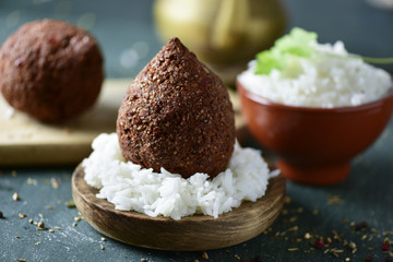 kibbeh, a levantine dish, on a rustic wooden table.