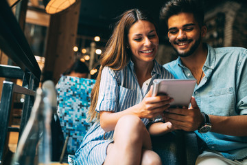 Young attractive couple on date in coffee shop