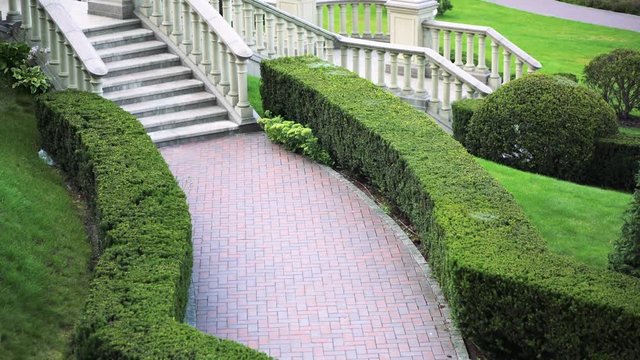 Formal garden. Recreation park with ornamental garden and stone stairs. Landscape design. A place for rest and relaxation