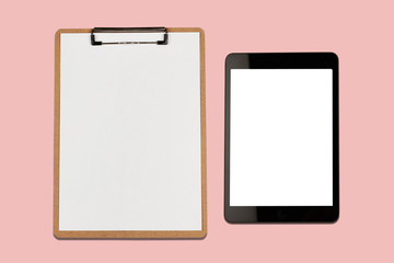 Digital tablet with blank screen and clipboard on pink background
