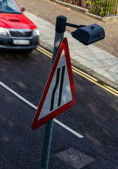 Unusual view of road narrows sign