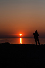 Fototapeta na wymiar silhouetted man on sunset background