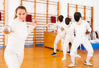  fencers at fencing workout, practicing attack movements