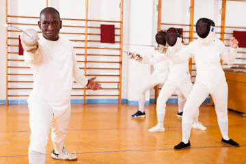 African american man fencer in training room