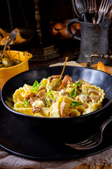 Reginette noodles in cream sauce with fresh chanterelles and capers