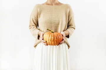 Young woman hold halloween pumpkin. Fall autumn concept.