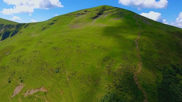 Aerial shot of a huge mountain with a spiky top in the Carpathians in summer
