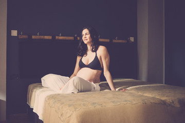 pregnant beautiful caucasian woman sitting on the floor and breathe to relax. new life concept at...
