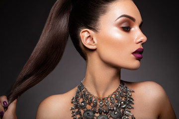 Beauty Brunette Woman with Perfect Makeup. Beautiful Professional Holiday Make-up. Red Lips,...