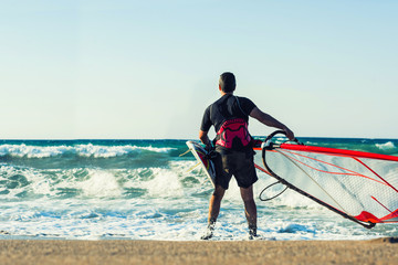 Windsurfer in the sea on Crete on sunset. Windsurfing in Heraklion
