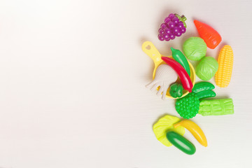 Toy fruits and vegetables. Kids toys. Vegetarian food on the table.
