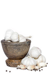 Garlic and black pepper in wooden mortar