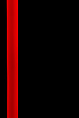 A red ribbon light on a dark wall