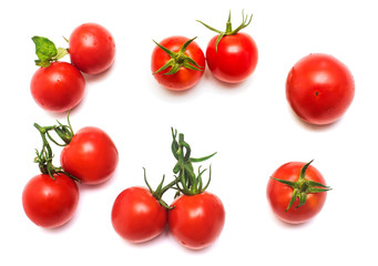 Tomatoes collection of whole and sliced with a branch of tomato leaf isolated on white background. Tasty and healthy food. Flat lay, top view