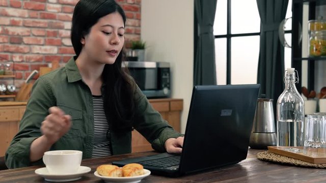 Girl typing and drink a cup of coffee.