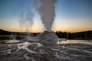 Castle Geysir erupting at twilight in Yellowstone National Park