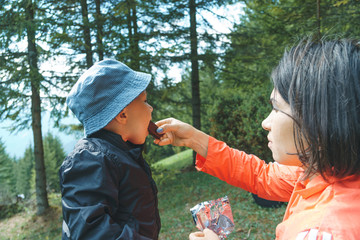 Mother Feeding Son with Chocolate