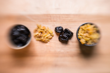 Prunes and raisins on wood board