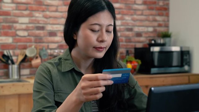 Woman online shopping using a credit card.