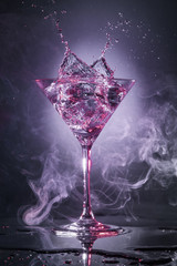 cocktail martini splashing isolated in a smoky grey background © popout