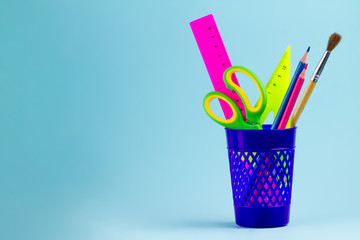 Stationery, school supplies on a blue background. School. Back to school. Copy space.