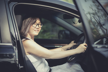 Fototapeta na wymiar asian woman fasten car seat belt before take a driving