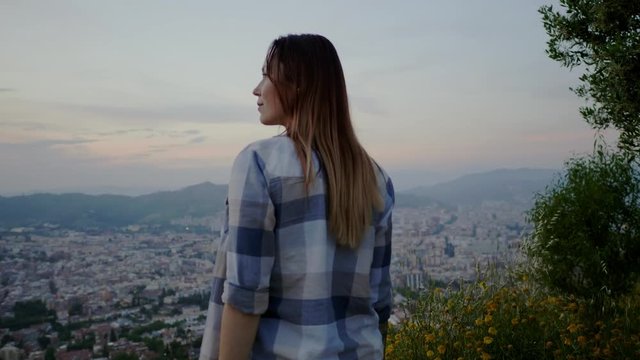 Beautiful woman enjoying Barcelona city view from Bunkers del Carmel, Spain