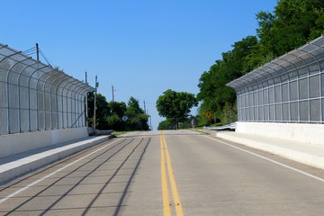 The bridge road over the highway on a sunny day.