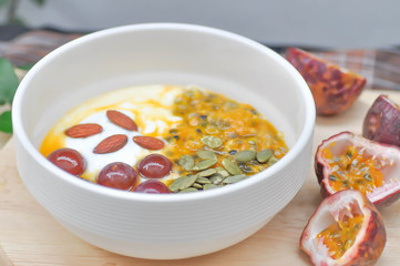yogurt with passion fruit, almond and grape topping