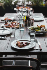 tasty pizza and salad on table at modern restaurant