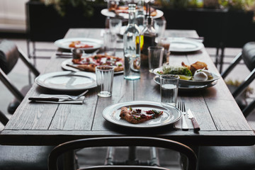 delicious pizza and salad on table at modern restaurant