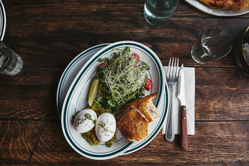 top view of healthy salad with sprouts and eggs on rustic wooden table