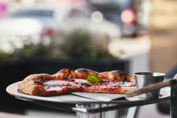 close-up shot of delicious pizza on tray and on blurred background