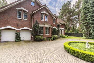Fototapeta na wymiar Luxury and large house in english style with garden and driveway