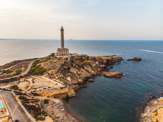 Lighthouse of Cabo de Palos, cape in the Spanish municipality of Cartagena, in the region of Murcia. Small spanish village, drone arial panoramic photo. Summer 2018 from drone