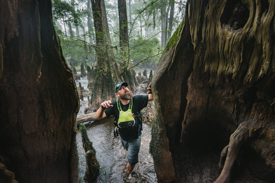 A male kayaker explores an old growth cypress swamp in the Black River, NC