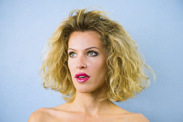 face of a pretty girl with curly hair and red lips closeup