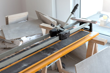 Cutter machine for ceramic tiles. A flat during renovation.