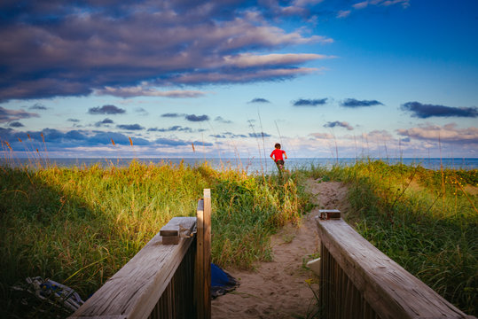 A little boy (Theo Kornylak) running on a beach in Eastern Florida