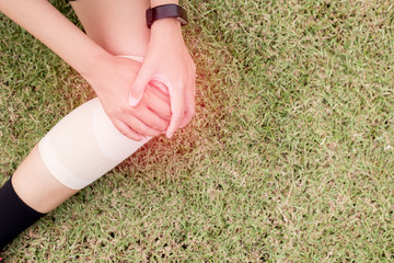 Woman suffering from pain in leg injury after sport exercise running jogging and workout outdoor