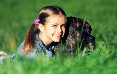smiling girl gently hugs a dog