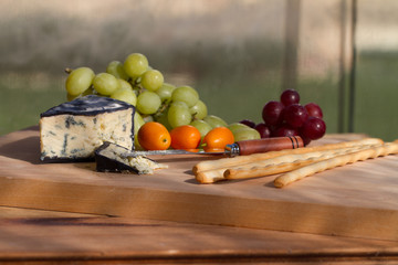 Cheese and Fruit Platter on Wooden Board