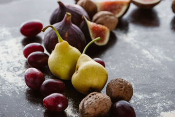 close up view of figs, pears and hazelnuts arranged on tabletop