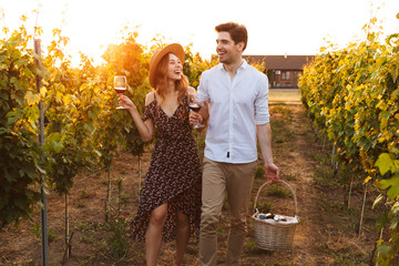Happy loving couple outdoors drinking wine