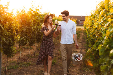 Happy loving couple outdoors drinking wine